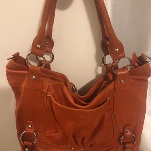 Genuine leather Chez orange handbag .Tons of detail and pockets outside and in.